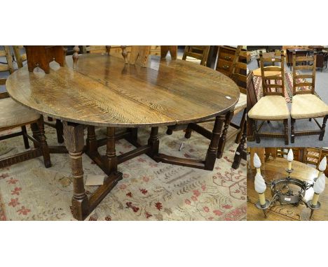 A 17th century style oak gateleg dining table, 160cm by 160cm, open by 73cm; a set of eight narrow ladder back dining chairs 