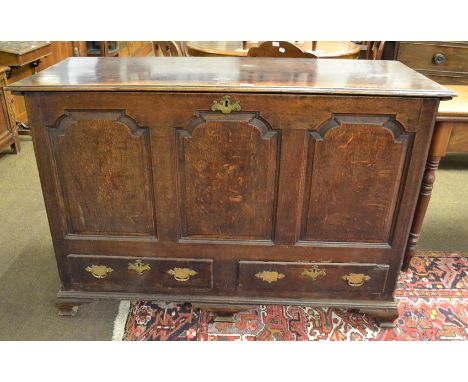 A George III oak mule chest, Lancashire region, late 18th century, the moulded hinged lid above three fielded panels, the bas