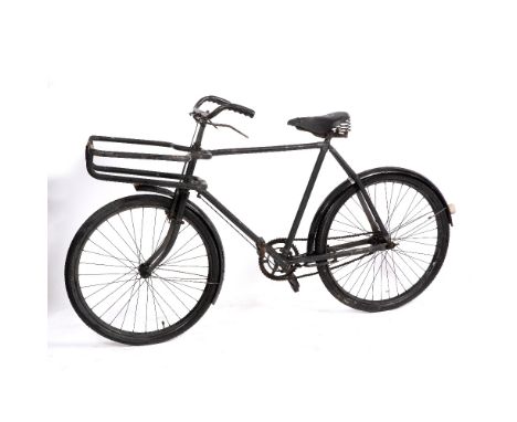 A BLACK PAINTED DELIVERY BICYCLE with Dunlop seat and front pannier rack, 20" frame