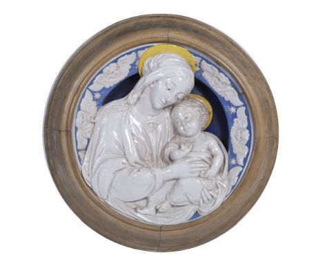 A 19TH CENTURY TIN GLAZED DELLA ROBBIA STYLE CIRCULAR PLAQUE depicting The Virgin and Child, set within a turned wooden frame