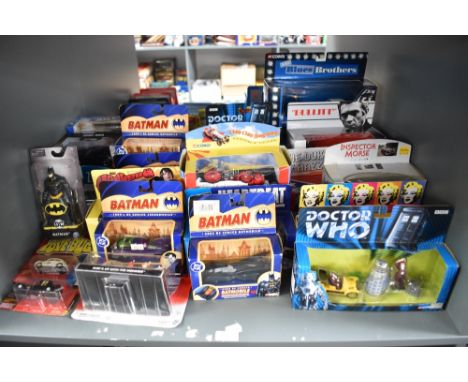 A shelf of modern TV related diecasts including DC Comics Batman, Doctor Who, Chitty Chitty Bang Bang, Blues Brothers etc, al