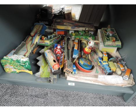 A shelf of modern Tin Plate Toys including clockwork Trains with Tracks, Cars, Animals etc, some boxed