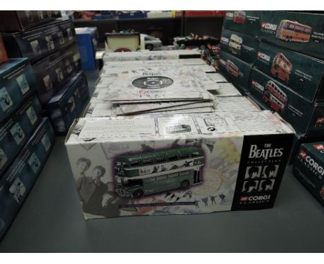 Seven 1997 Corgi Classics The Beatles Collection diecasts along with card and paper records with sleves, all boxed