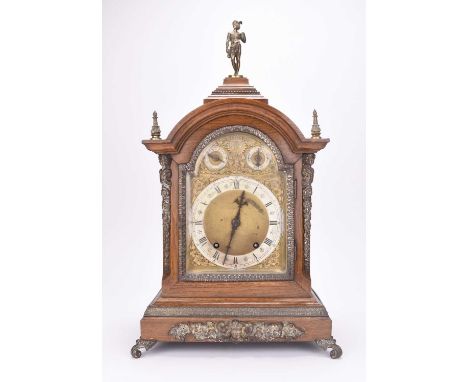 A German gilt metal mounted oak bracket clock, circa 1900The arch-top case surmounted by a figure of mercury, the sides with 