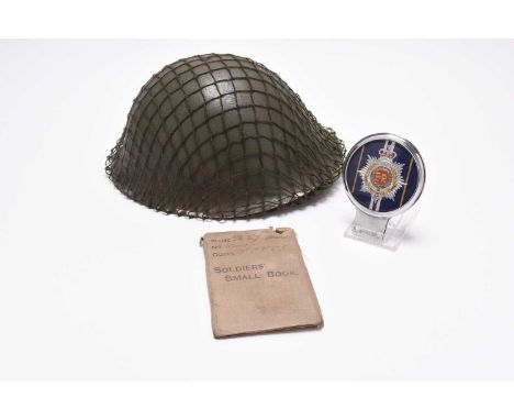 An assembled group of militaria to include: A British Army MKIV helmet dated 1979, with exterior net; a First World War Soldi