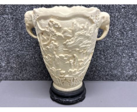 Vintage faux ivory (resin) vase with 3D relief carvings &amp; twin elephant head handles, on wooden plinth - Height 29.5cm