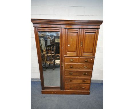 A LATE 19TH EARLY 20TH CENTURY MAPLE AND CO WALNUT COMPACTIUM WARDROBE, loose overhanging cornice, a single mirrored door, tw