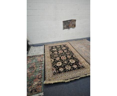 A SELECTION OF RUGS, to include a cream floral rug with a central black ground, 230cm x 160cm, a  small green Chinese rug, 14