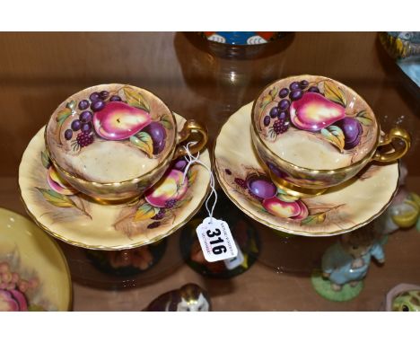 A PAIR OF AYNSLEY ORCHARD GOLD TEA CUPS AND SAUCERS, with gilt handles and rims, printed with fruit inside and out, N Brunt s