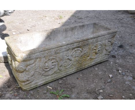 A MODERN RECTANULAR GARDEN PLANTER with South American designs to each facet, width 72cm, depth 24cm and height 26cm (Conditi