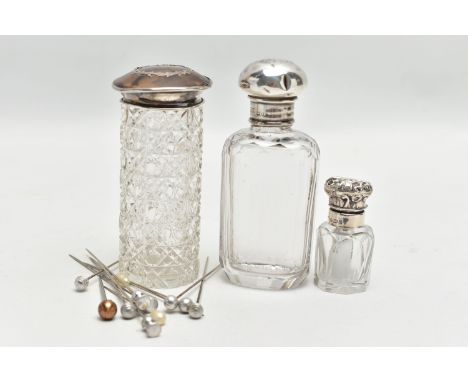 A SELECTION OF GLASS BOTTLES WITH SILVER LIDS AND STICK PINS, to include an early 20th century textured cylindrical glass bot