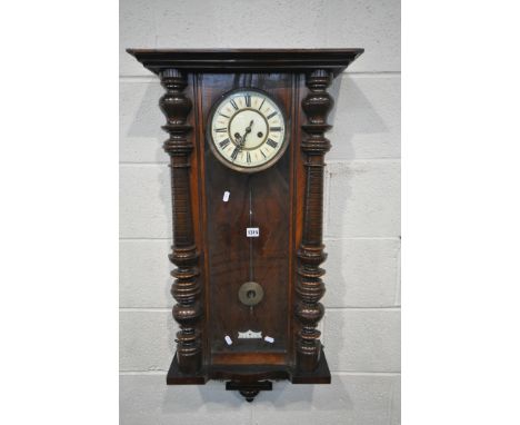 A LATE 19TH CENTURY WALNUT VIENNA WALL CLOCK, the 7 inch enamel dial with roman numerals, height 101cm, with winding key and 