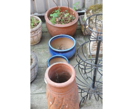 A VINTAGE TERRACOTTA CHIMNEY POT height 63cm, a large terracotta colour glazed planter diameter 52cm, three blue glazed pots 