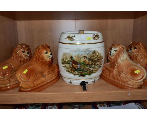 ONE PAIR AND TWO SIMILAR STAFFORDSHIRE RECUMBENT LIONS TOGETHER WITH A CERAMIC BEER BARREL decorated with game birds, with ta