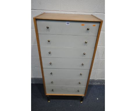 A MID CENTURY OAK G PLAN E GOMME CHEST OF SEVEN DRAWERS, on ebonised legs, and brass feet, width 61cm x depth 41cm x height 1