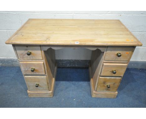 A 19TH CENTURY PINE KNEE HOLE DESK, with two banks of three drawers, width 114cm x depth 62cm x height 80cm (condition - hist