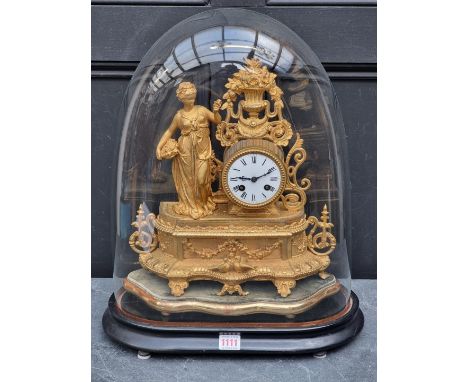 A Victorian gilt spelter mantle clock, 34cm&nbsp;high, on giltwood stand, with further ebonized stand and glass dome, total h