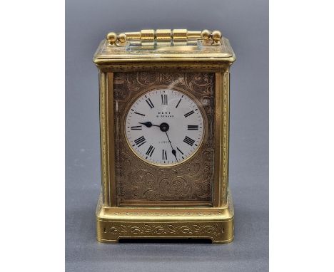 A small antique engraved brass carriage timepiece, the enamel dial inscribed 'Dent, 61 Strand, London', height including hand