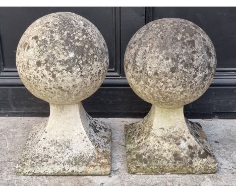 An old pair of weathered composition stone gate pier finials, largest 50cm high.