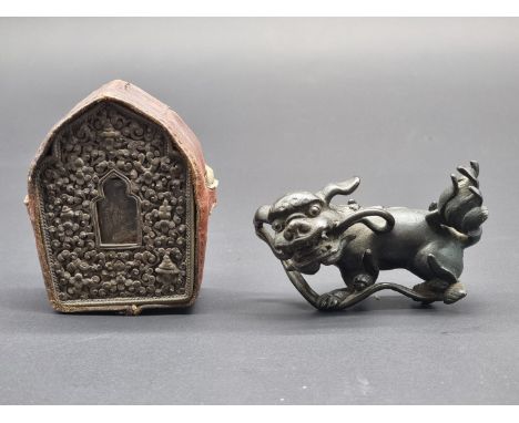A small Chinese bronze lion dog,&nbsp;8cm high; together with a small 19th century Tibetan Gau prayer box, 9cm. (2)