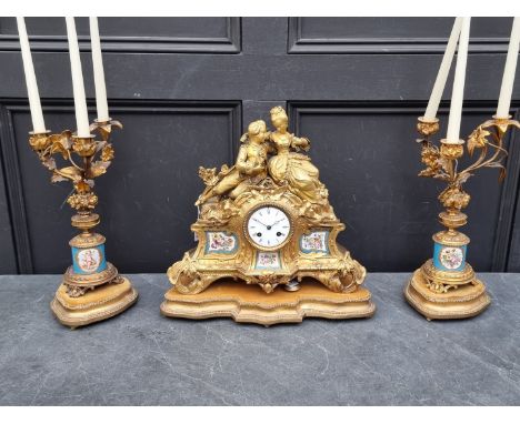 A matched 19th century gilt brass and Sevres style clock garniture, the clock 35.5cm high, the pair of associated three branc