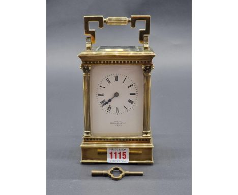 A large brass carriage clock,&nbsp;striking on a gong, the enamel dial inscribed 'Upjohn, Bright &amp; Co, London', height in