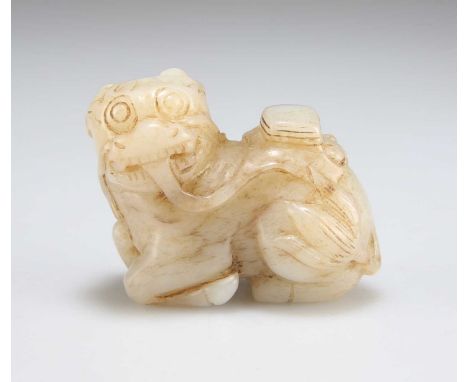 A CARVED JADE QILIN the figure recumbent. 4.5cm high, 5cm wide