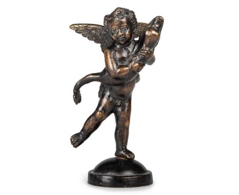 A PATINATED BRONZE MODEL OF A PUTTO WITH A DOLPHIN after Andrea del Verrocchio (1435-1488), on a domed circular base. 12cm hi