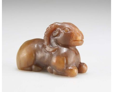 A JADE TOGGLE carved as a recumbent ram. 5.8cm longIn good condition.