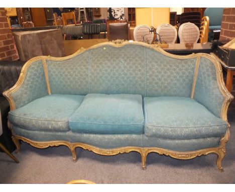 A VINTAGE UPHOLSTERED 3 SEATER WINGBACK SOFA WITH CARVED DETAIL