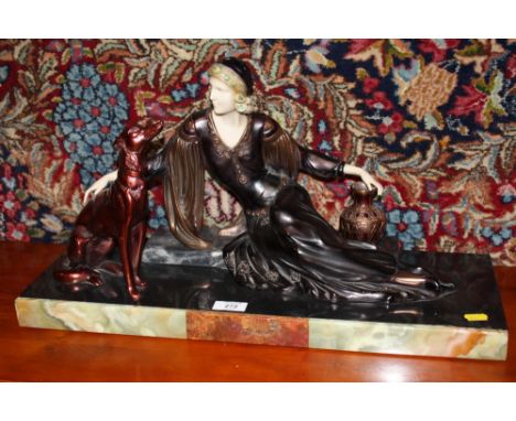 A VINTAGE FIGURE OF AN ART DECO LADY AND A RED SETTER DOG RAISED ON A ONYX AND MARBLE PLINTH