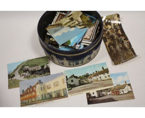 A TIN OF VINTAGE POSTCARDS