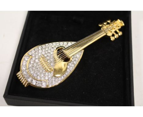 A SWAROVSKI CRYSTAL LUTE SHAPED BROOCH