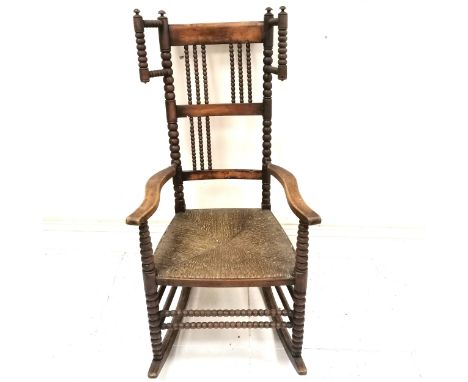 Antique Arts &amp; Crafts (Libertys?) rush seated rocking chair with bobbin turnings - 115cm high x 57cm wide ~ 3 turnings mi