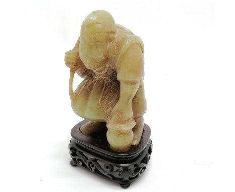 Oriental Chinese antique hand carved jade figure of a fisherman on a carved wooden stand with an old Sotheby's label on under