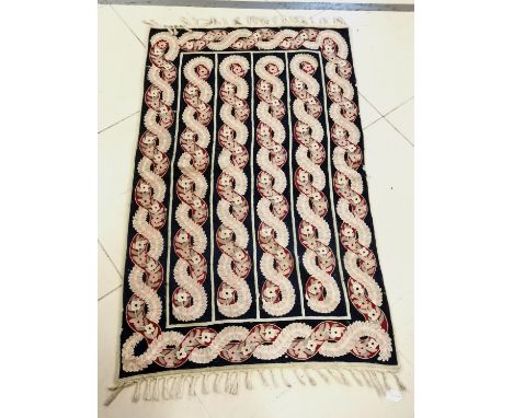 Vintage crewel work rug with all over red and blue floral decoration. 90 cm wide 160 length. with signs of moth. 