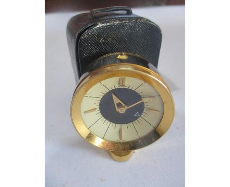 A Jaeger travel alarm clock ( stamped 73 to base) in leather case- case A/F
