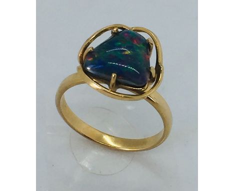 A 9 ct gold ring set with an irregular shaped black opal, size N