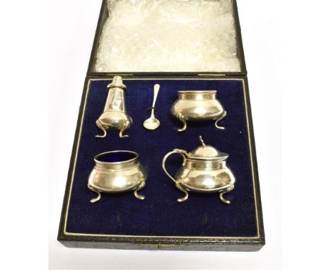 A BOXED FOUR PIECE CONDIMENT SET AND SALT SPOON comprising two salts, a pepperette and mustard of round cauldron shape on thr