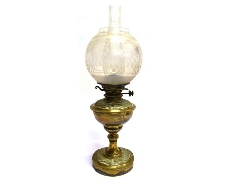 AN EDWARDIAN BRASS OIL LAMP  with etched glass shade, 58cm high