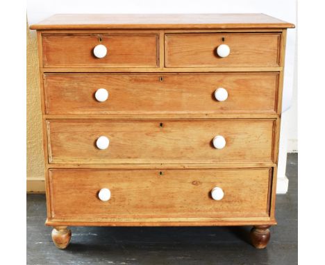A PINE CHEST OF TWO SHORT AND THREE LONG DRAWERS  with ceramic handles on bun feet, 117cm wide 54cm deep 108cm high