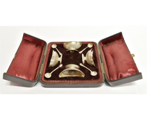A VICTORIAN CASED SET OF FOUR SILVER SALTS AND SPOONS of oval half fluted classical form each approx. 75mm x 45mm, with origi