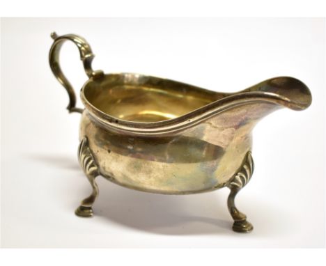 A GEORGIAN SILVER SAUCE BOAT by Walter Brind, London marks for 1770, of traditional form with Acanthus leaf, scroll handle, w