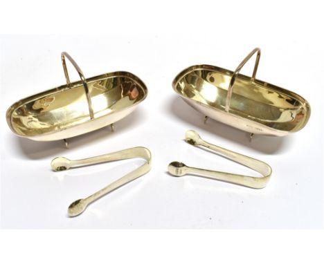A PAIR OF EDWARDIAN SUGAR TROUGHS AND SUGAR NIPS the two faceted silver troughs with carrying handle, each complete with a pa