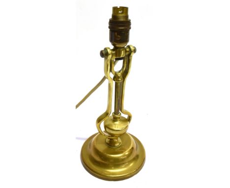 A GIMBALLED BRASS TABLE LAMP  with weighted base, suitable for wall mounting or as a table lamp, stamped 'PLAYMIT AP9009', 31