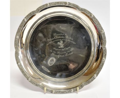 OF LOCAL INTEREST - A SILVER PRESENTATION DISH the three footed shallow round dish with Celtic design lobed borders, presenta