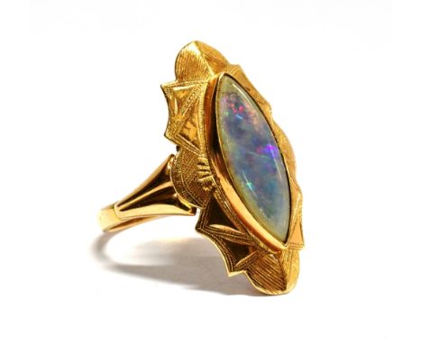 A BLACK OPAL SINGLE STONE 14CT GOLD RING the marquise shaped cabochon cut opal 15 x 6mm to fancy engraved pattern marquise sh