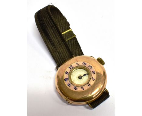 A 14CT GOLD EARLY WRIST WATCH (conversion from a pocket watch) half hunter design, pink enamel outer chapter ring, 33mm case 