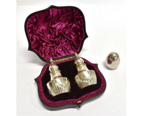 A BOXED PAIR OF VICTORIAN SILVER EGG FORM PEPPERETTES by Mappin and Webb, on three bun feet, hallmarks for Sheffield 1898 wei