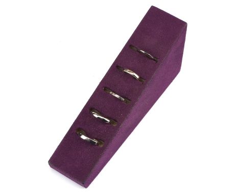 † A selection of five wedding bands, including a 2mm knife edge profile band in platinum, size K, together with a 3mm D-shape